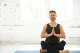 storyblocks-young-guy-with-eyes-closed-sitting-on-a-fitness-mat-and-meditating-in-the-gym_rAGx7Znp5Z.jpg