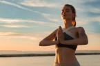 storyblocks-picture-of-young-sports-lady-at-the-beach-make-meditate-exercises_H0lDYS3T5b.jpg